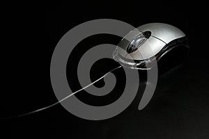 Mouse computer, wired, silver on a dark background