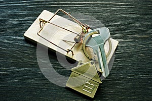 Mousetrap and house keys. Mortgage fraud Home buying scam.