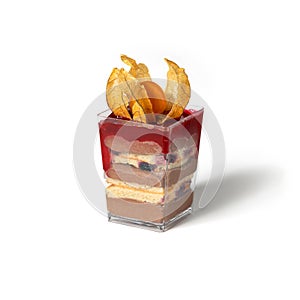 Mousse pudding with biscuit cake and berries in glass cup on white background. Candy bar, sweets and dessert, selective focus