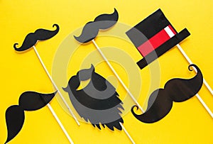 Moustache photo booth props on yellow background. Moustache cut outs. Prostate Cancer Awareness, Men health awareness concept