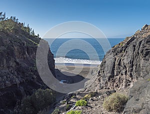 Mouth of Barranco de Guigui Grande gorge with view of empty sand beach Playa de Guigui in west part of the Gran Canaria