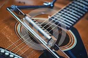 Mouth harmonica resting on acoustic guitar