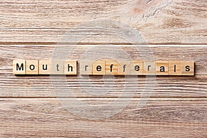 Mouth refferals word written on wood block. mouth refferals text on table, concept