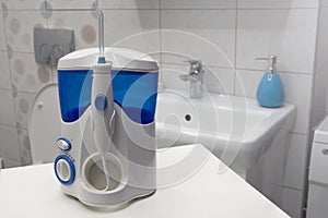 Mouth teeth cleaning irrigator modern tool in bathroom. Oral hygiene, bathroom objects concept