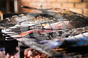 Mouth watering fresh fish cooking on barbeque on spanish coast