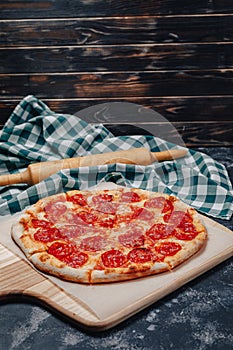 Mouth-watering Neapolitan pizza on a blackboard with various ingredients, free space for text
