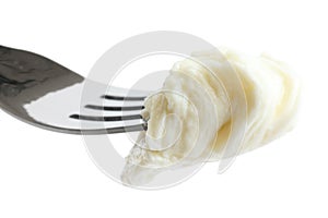 Mouthful of torn mozzarella on fork, isolated.