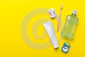 Mouthwash and other oral hygiene products on colored table top view with copy space. Flat lay. Dental hygiene. Oral care