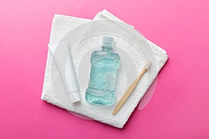 Mouthwash and other oral hygiene products on colored table top view with copy space. Flat lay. Dental hygiene. Oral care