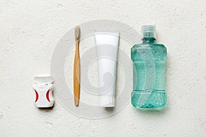 Mouthwash and other oral hygiene products on colored table top view with copy space. Flat lay. Dental hygiene. Oral care