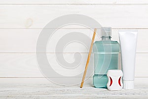 Mouthwash and other oral hygiene products on colored table top view with copy space. Flat lay. Dental hygiene. Oral care