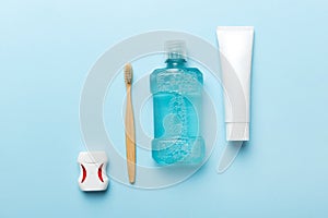 Mouthwash and other oral hygiene products on colored table top view with copy space. Flat lay. Dental hygiene. Oral care