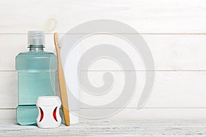 Mouthwash and other oral hygiene products on colored table top view with copy space. Flat lay. Dental hygiene. Oral care