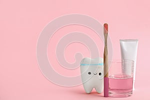 Mouthwash, toothbrush, paste and holder on pink background. Space for text