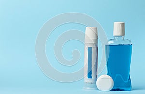 Mouthwash, toothpaste tube, dental floss on a blue background, oral hygien photo