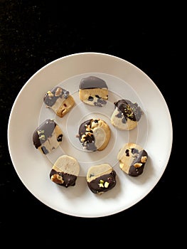 Mouthwatering platter of homemade Lemon, cranberry, walnut dark chocolate dipped cookies