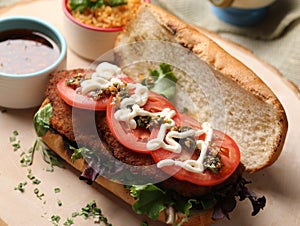 Mouthwatering sandwich with meat, greens, tomatoes and mayonnaise