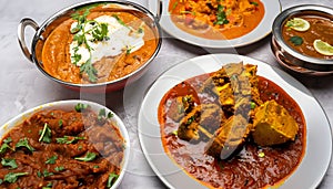 A mouthwatering spread of different curries, such as butter chicken and karahi gosht