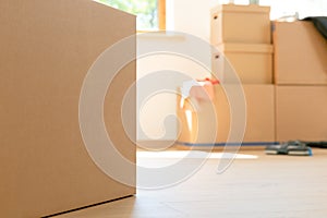 Move. Cardboard boxes for moving into a new, clean home. In a sunny day by a window in attic