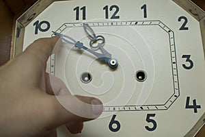 Move the hands of a large mechanical clock by hand