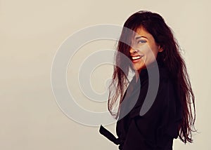 Move and take. Beautiful happy bright woman with long brown healthy hair style in black shirt and skirt posing