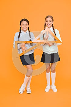 Move from theory to practice. Excellent pupils. Secondary school. Schoolgirls tidy appearance school uniform hold big