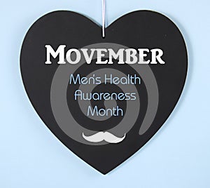 Movember fundraising for mens health awareness message on blackboard photo