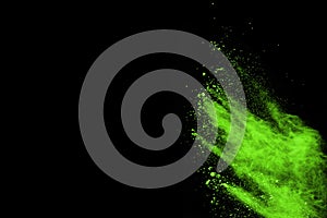 The movement of abstract dust explosion frozen green on black background.
