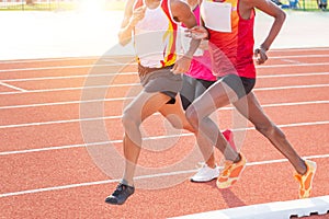 Movement athletes sprint running on running track in stadium