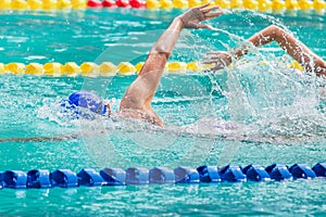 Movement of athletic swimmers swimming freestyle stroke front crawl or forward crawl during competition