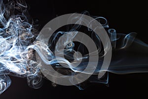 Movement of blue and white smoke abstract on black background