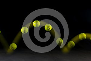 Movement or bounce of tennis ball isolated on black background