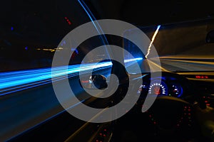 Movement of the car at night on the country highway at a high speed of viewing from the inside with the driver. Hand on