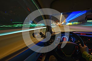 Movement of the car at night on the country highway at a high speed of viewing from the inside with the driver. Hand on