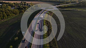 movement of cars on the highway at sunset in summer. aerial drone shooting