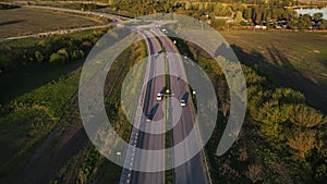 movement of cars on the highway at sunset in summer. aerial drone shooting