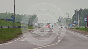 The movement of a convoy of trucks and cars on a wet road in bad weather. Export and import cargo transportation concept