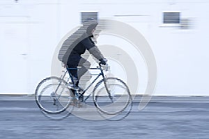 movement of a cyclist with black jacket on white background