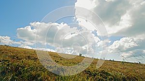 Movement in the field from the first person, side view, Warm sun rays peeking through fluffy clouds over a tranquil