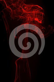 Movement of red smoke on black background