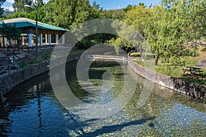 Stream of transparent water and pebbles with weir in the background, beach and park of PoÃ§o de Corga PORTUGAL photo