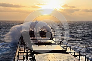 The movement of the vessel against the waves during a heavy storm. Sunset.North Pacific ocean.