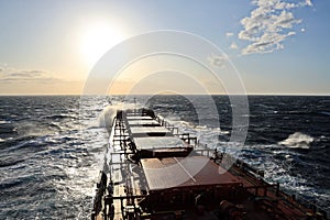 The movement of the vessel against the waves during a heavy storm. Sunset.North Pacific ocean.