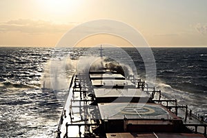 The movement of the vessel against the waves during a heavy storm. Sunset.North Pacific ocean.