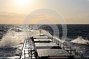 The movement of the vessel against the waves during a heavy storm. Sunset.North Pacific ocean.