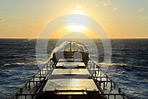 The movement of the vessel against the waves during a heavy storm. Sunset.North Pacific ocean.