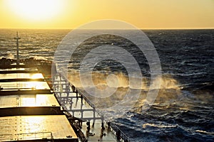The movement of the vessel against the waves during a heavy storm. Sunset.North Pacific ocean.