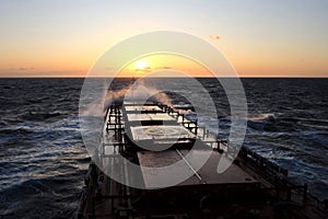 The movement of the vessel against the waves during a heavy storm. Sunset.North Pacific ocean.