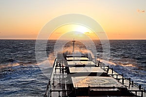 The movement of the vessel against the waves during a heavy storm. Sunset.North Pacific ocean.