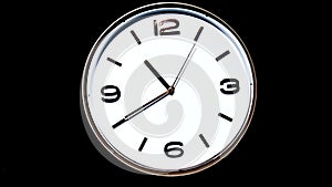 Movements of analog white face clock at 10:00 to 11:00